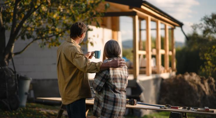 couple in front of a house