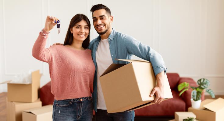 couple with home keys moving in