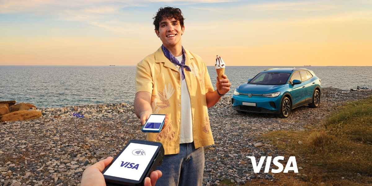 Man holding POS and car in the background