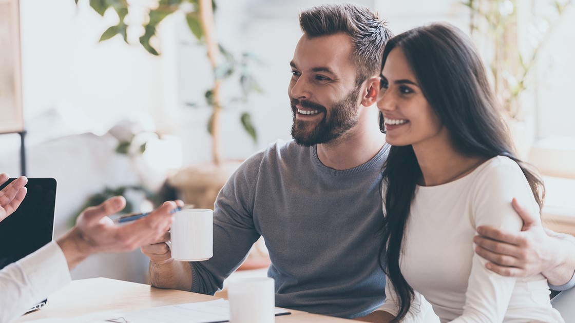 Monthly interest - Couple drinking coffee during meeting